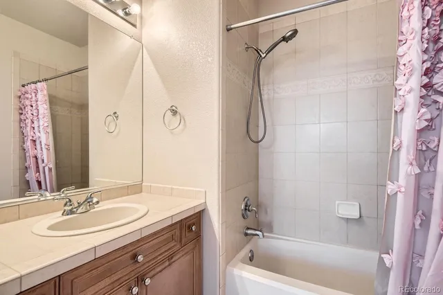 a en suite bathroom with a sink double vanity and a mirror