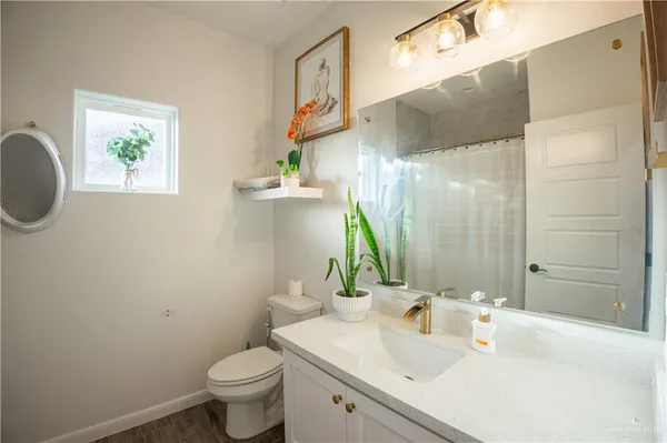 a bathroom with a sink toilet and a mirror