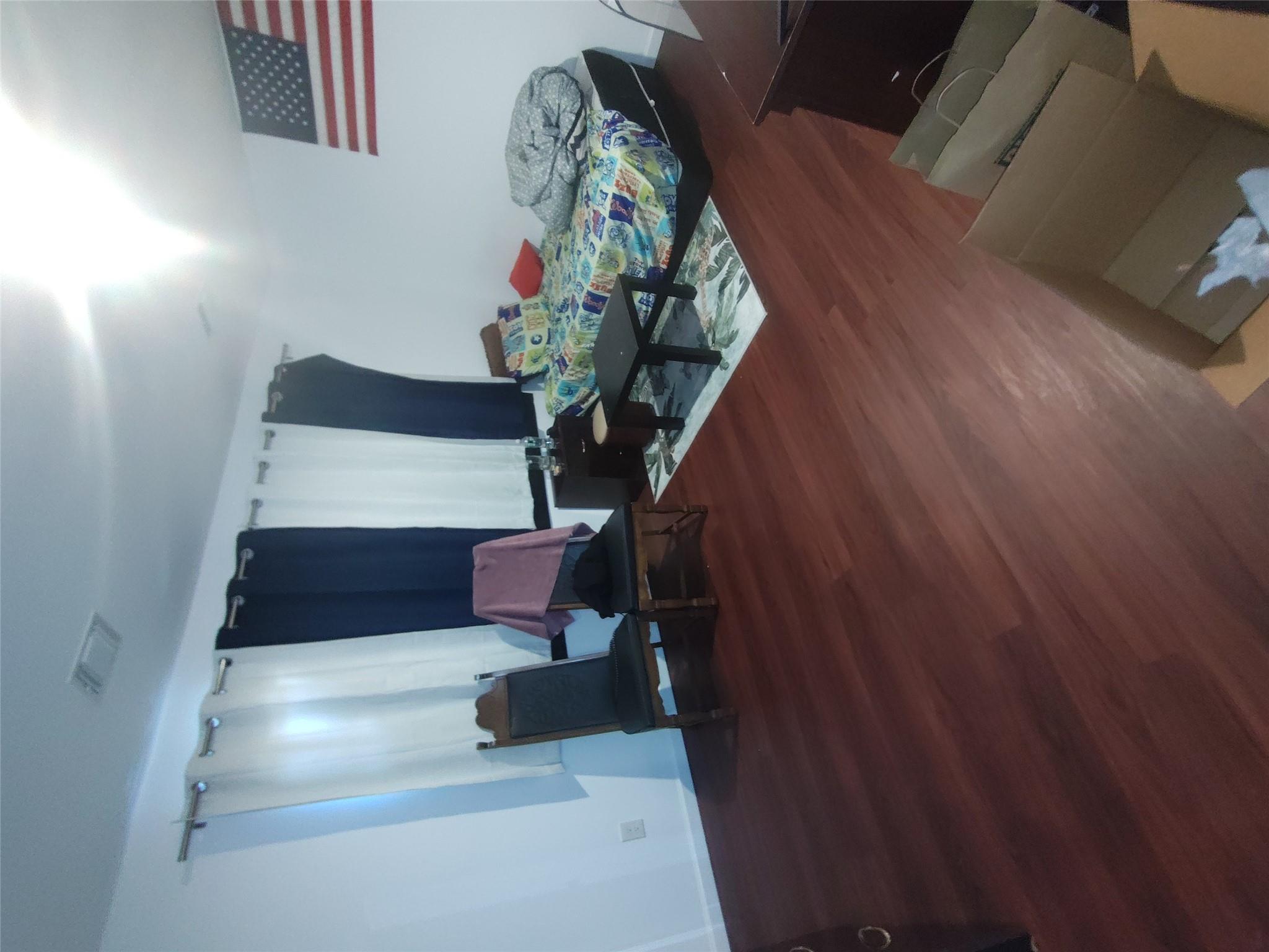 2167 A Great Neck Road Copiague, NY 11726 - Photo 11 of 18 Bedroom featuring wood finished floors and baseboards