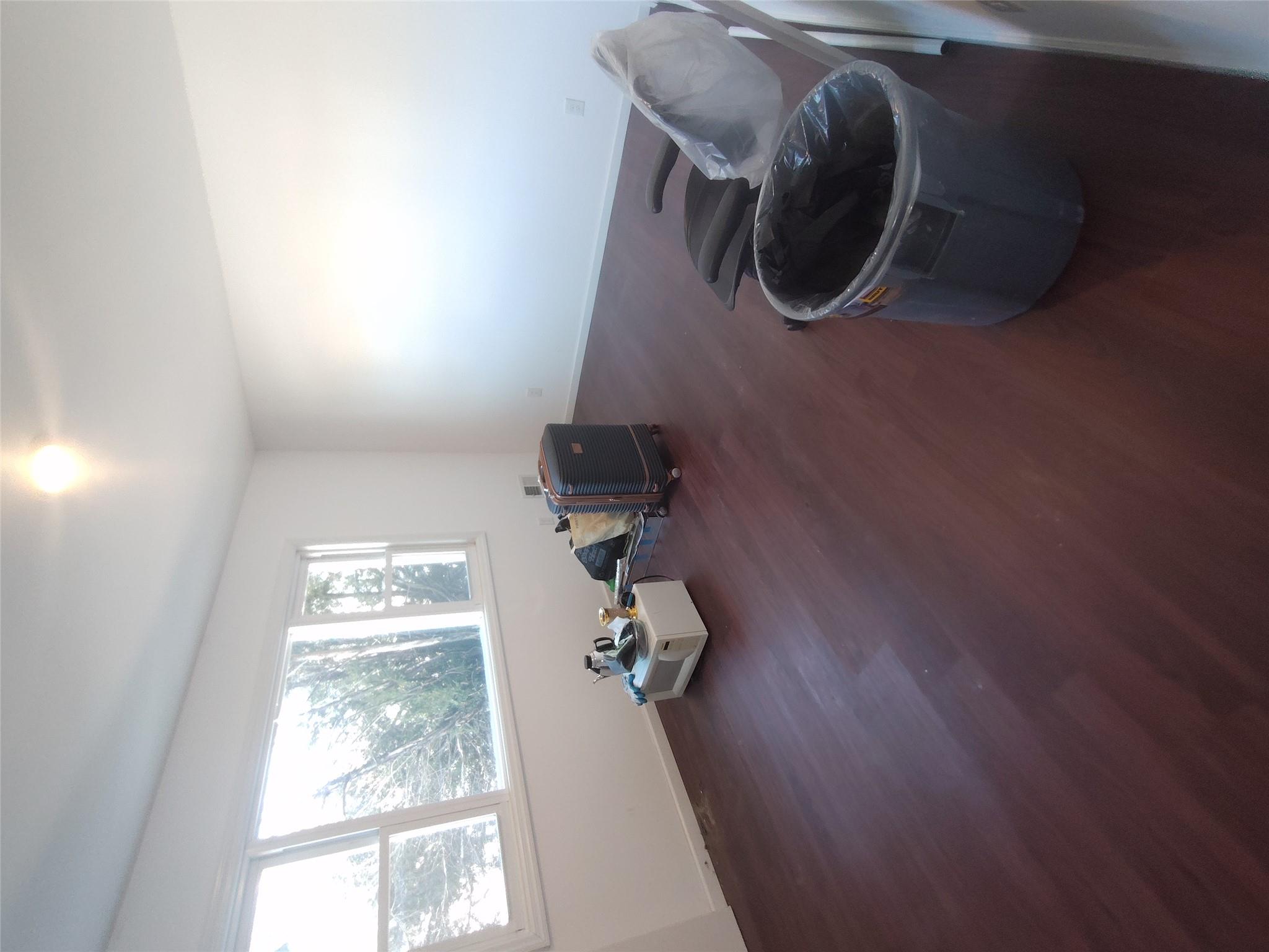 2167 A Great Neck Road Copiague, NY 11726 - Photo 4 of 18 Unfurnished room with dark wood-style floors and baseboards