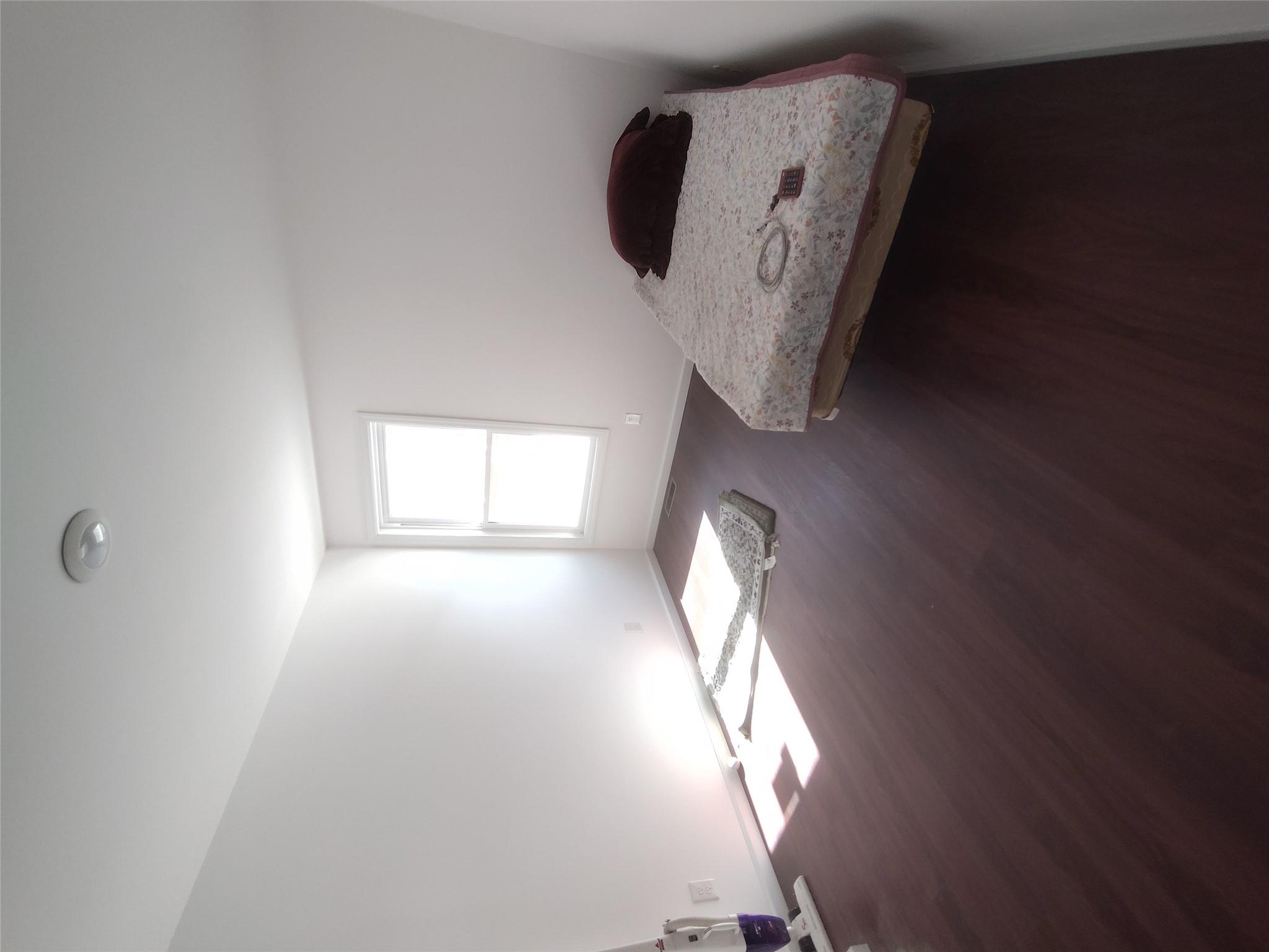 2167 A Great Neck Road Copiague, NY 11726 - Photo 7 of 18 Bedroom featuring dark wood finished floors and baseboards