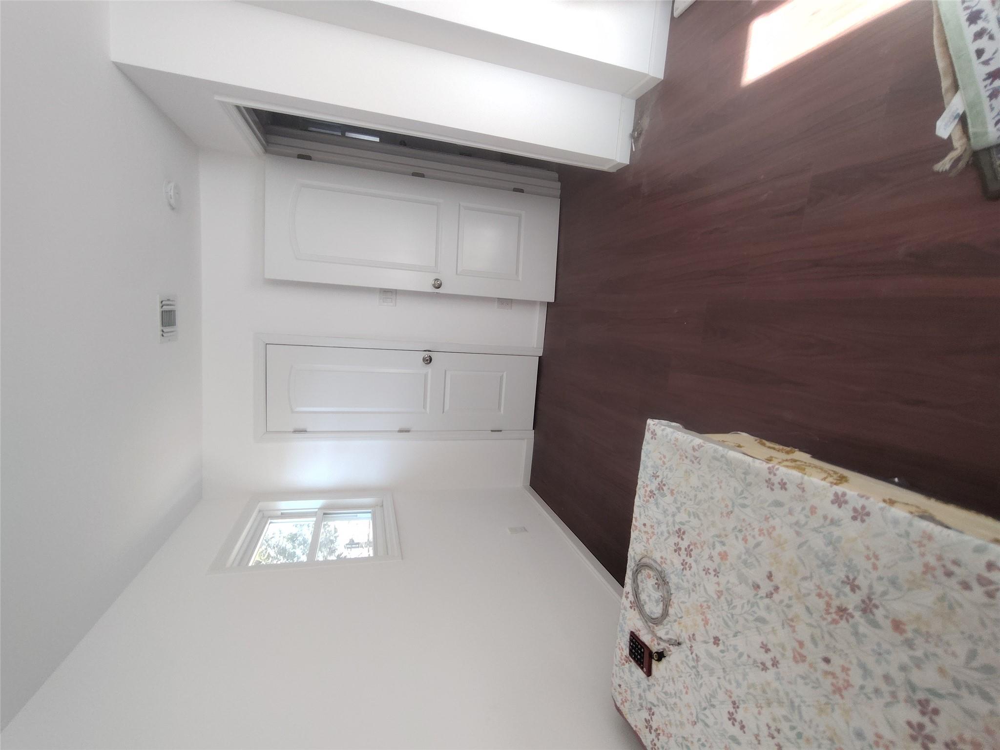 2167 A Great Neck Road Copiague, NY 11726 - Photo 8 of 18 Unfurnished bedroom with dark wood finished floors and baseboards