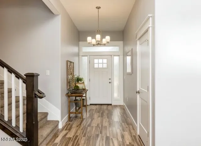 a view of a room with wooden floor staircase and windows