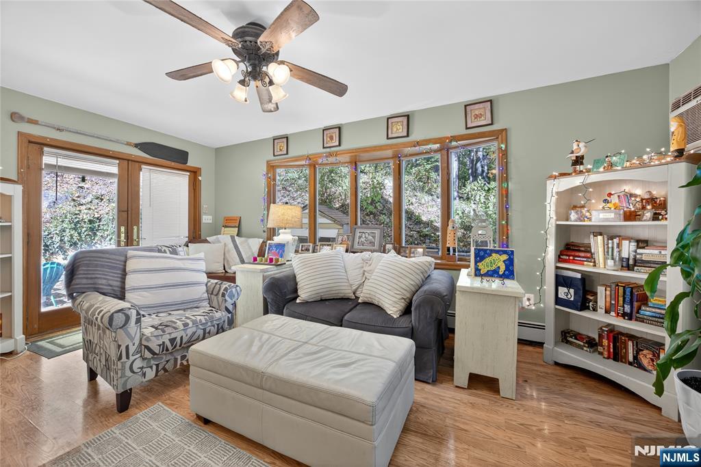 370 Goffle Road Hawthorne, NJ 07506 - Photo 12 of 37 a living room with furniture and a large window with bookshelf