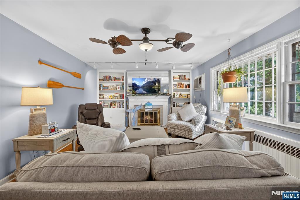 370 Goffle Road Hawthorne, NJ 07506 - Photo 13 of 37 a living room with furniture ceiling fan and a window