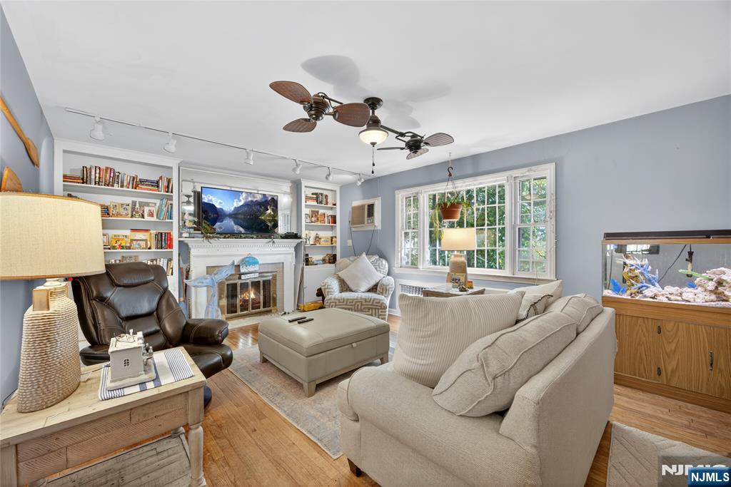 370 Goffle Road Hawthorne, NJ 07506 - Photo 3 of 37 a living room with furniture fireplace and a large window