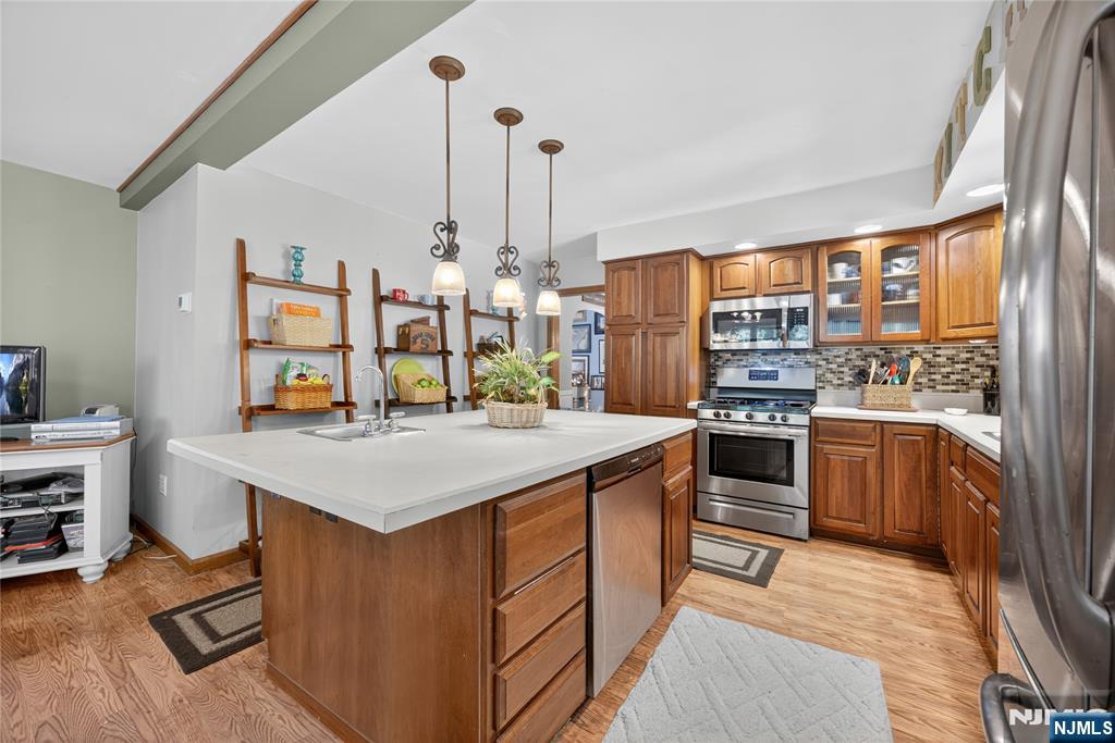 370 Goffle Road Hawthorne, NJ 07506 - Photo 9 of 37 a kitchen that has a lot of cabinets a sink and a stove in it