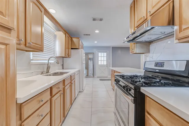 a bathroom with a double vanity sink toilet and shower