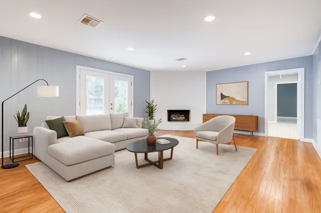 a bedroom with a bed couch and a window