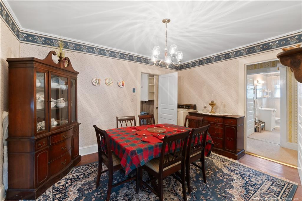 6131 Stewart Road Godwin, NC 28344 - Photo 11 of 27 a view of a dining room with furniture window and wooden floor