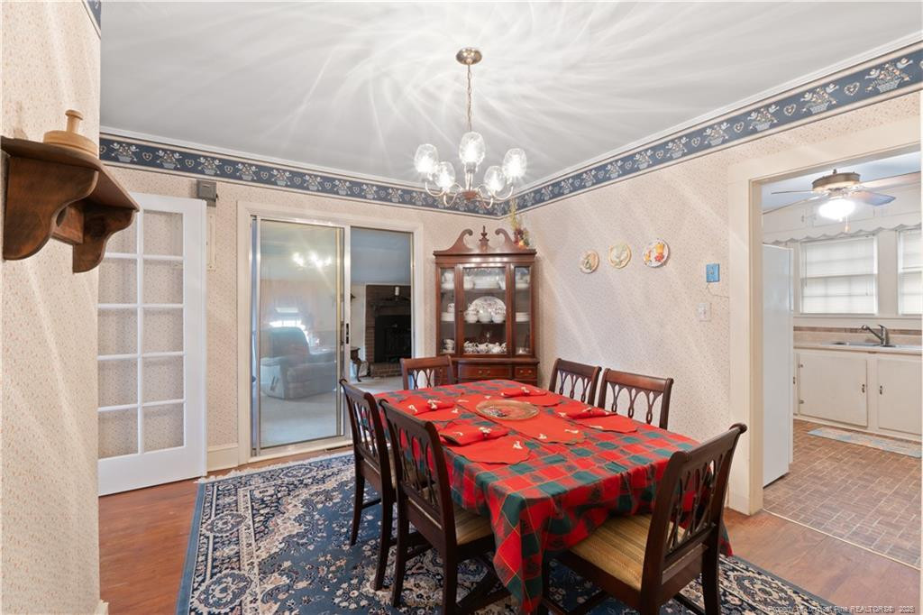 6131 Stewart Road Godwin, NC 28344 - Photo 12 of 27 a view of a dining room with furniture and chandelier