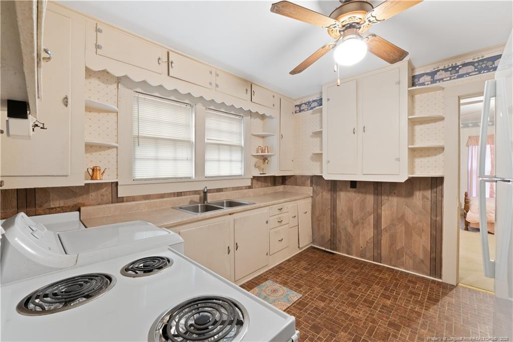 6131 Stewart Road Godwin, NC 28344 - Photo 15 of 27 a kitchen with a refrigerator and a sink