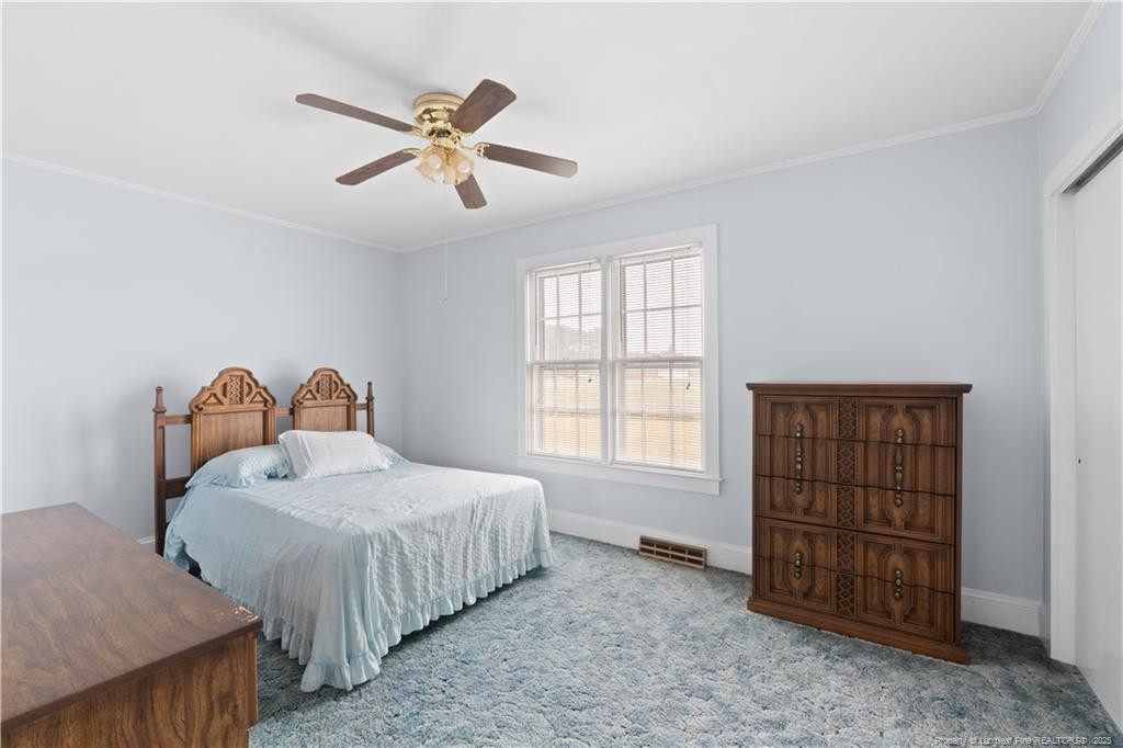 6131 Stewart Road Godwin, NC 28344 - Photo 18 of 27 a bedroom with a bed and a cabinets