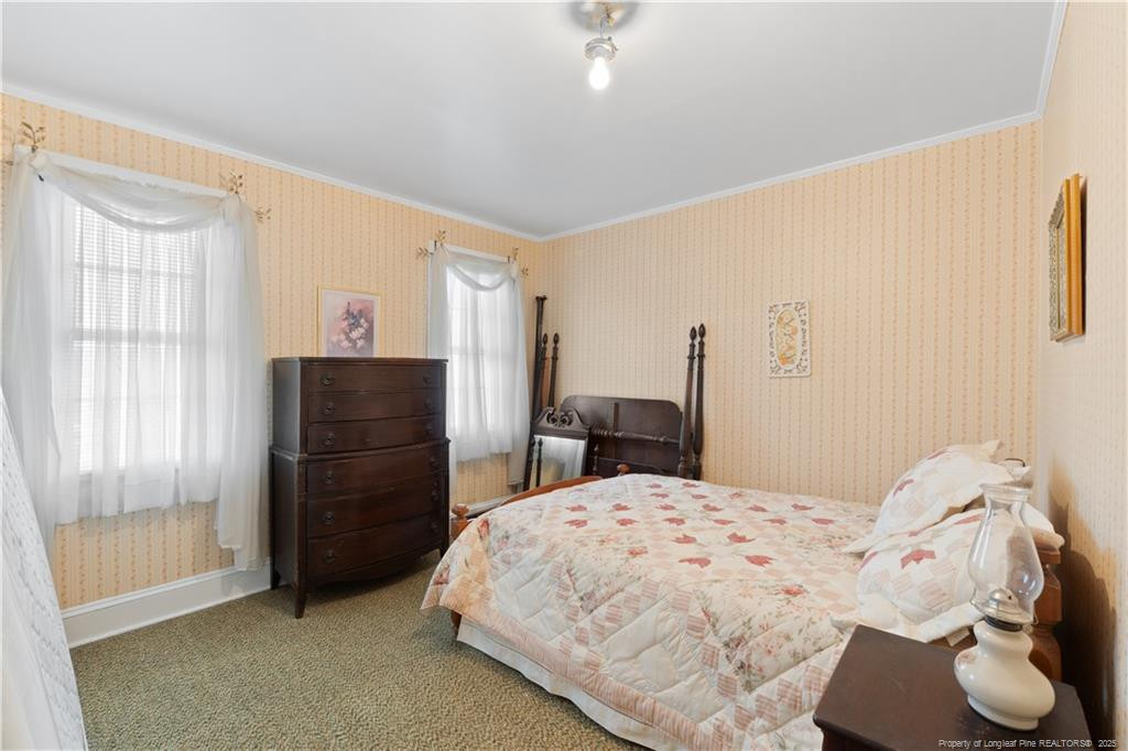 6131 Stewart Road Godwin, NC 28344 - Photo 21 of 27 a bedroom with a bed and a refrigerator