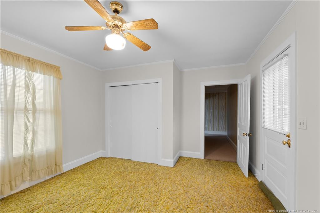 6131 Stewart Road Godwin, NC 28344 - Photo 27 of 27 a view of an empty room with window and chandelier fan