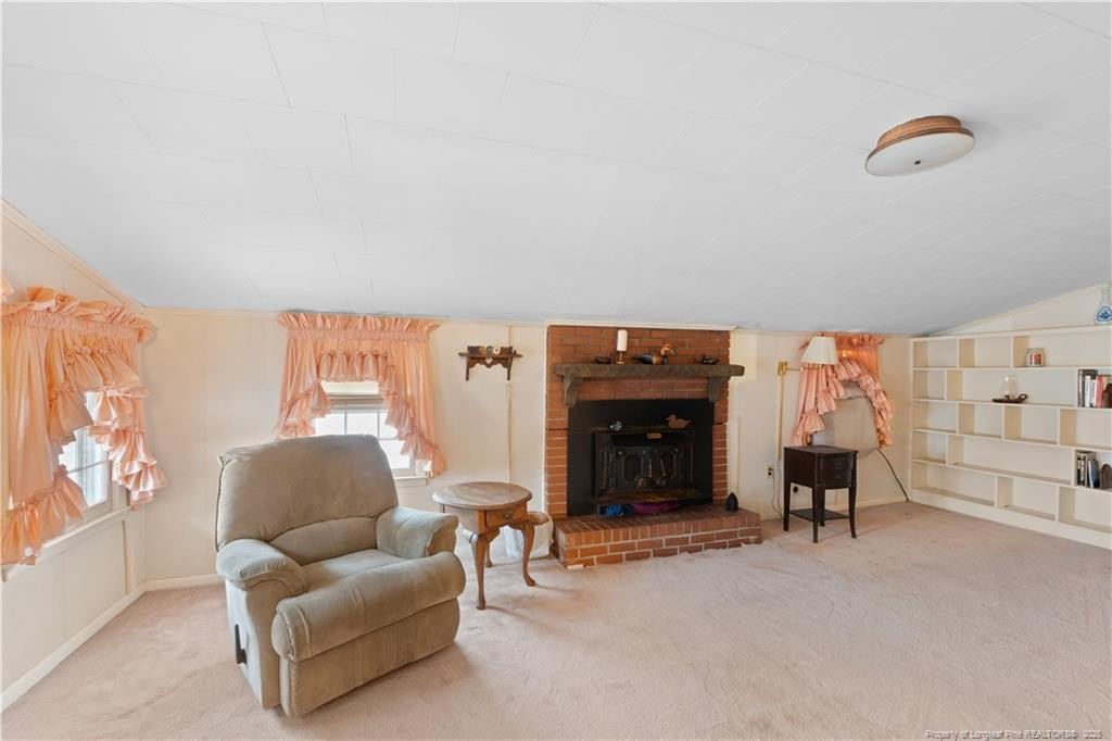6131 Stewart Road Godwin, NC 28344 - Photo 9 of 27 a living room with furniture and a fireplace