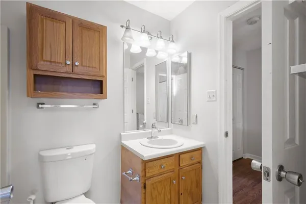 a bathroom with a sink a toilet and a mirror