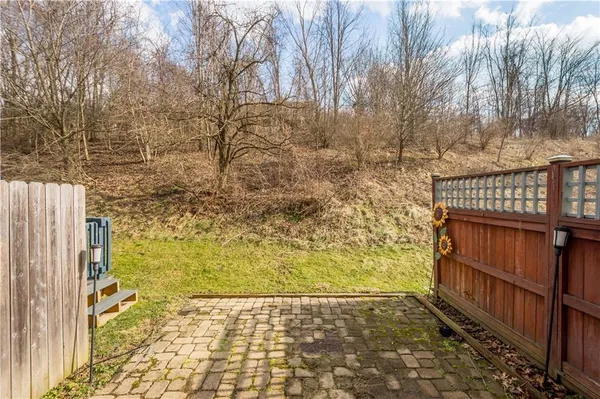 a view of a house with wooden fence