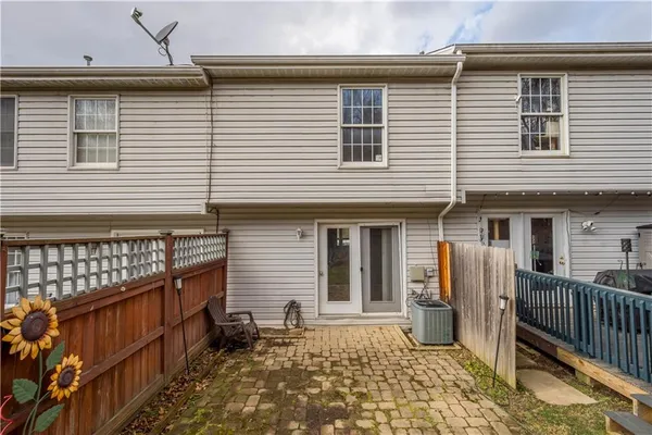 a view of a house with wooden fence