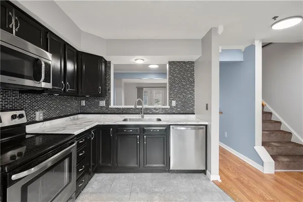 a kitchen with a sink stove and cabinets