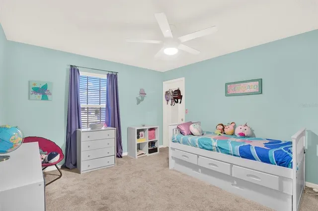 a bedroom with furniture and baby crib