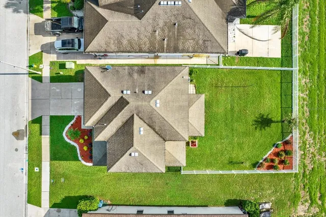 an aerial view of residential houses with outdoor space and swimming pool