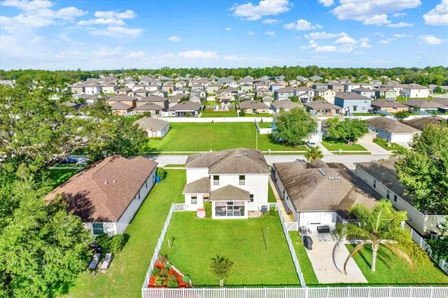 an aerial view of a house with garden space and outdoor seating