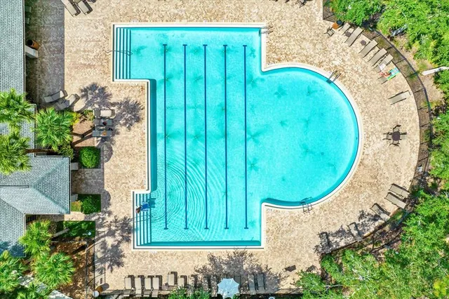 an aerial view of a house with a yard and lake view