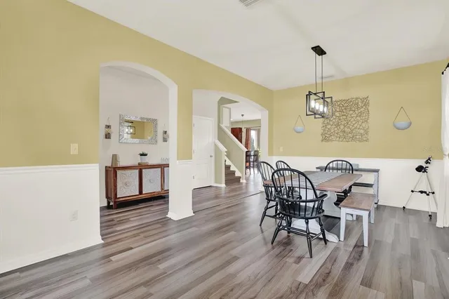 a view of a dining room with furniture and wooden floor