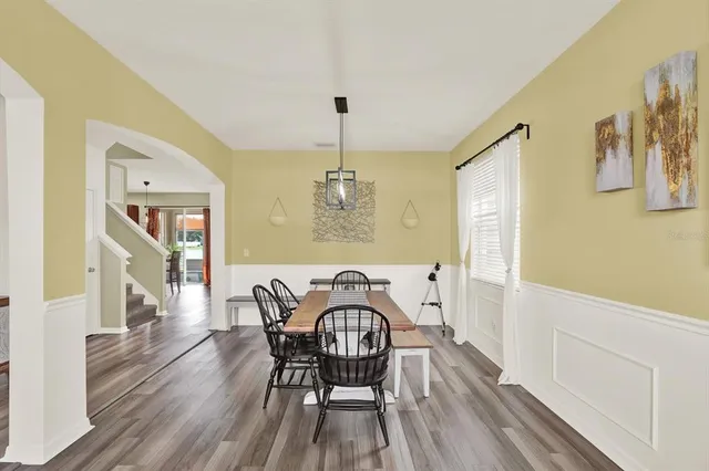 a view of a dining room with furniture window and wooden floor