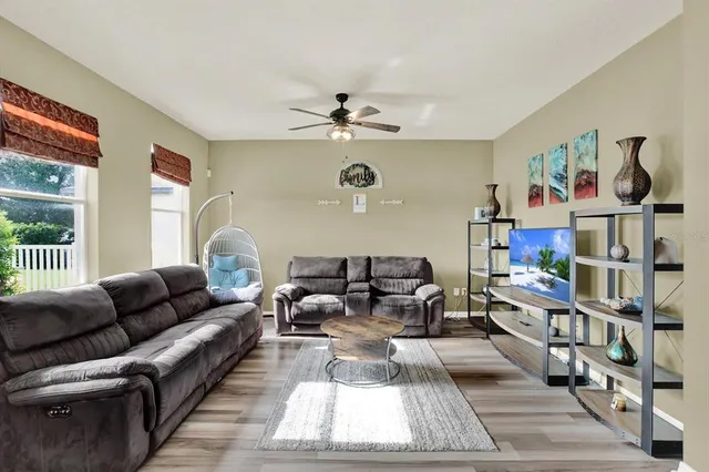 a living room with furniture a rug and a window