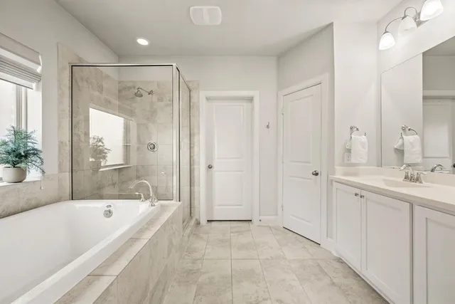 a bathroom with a bathtub shower and a sink