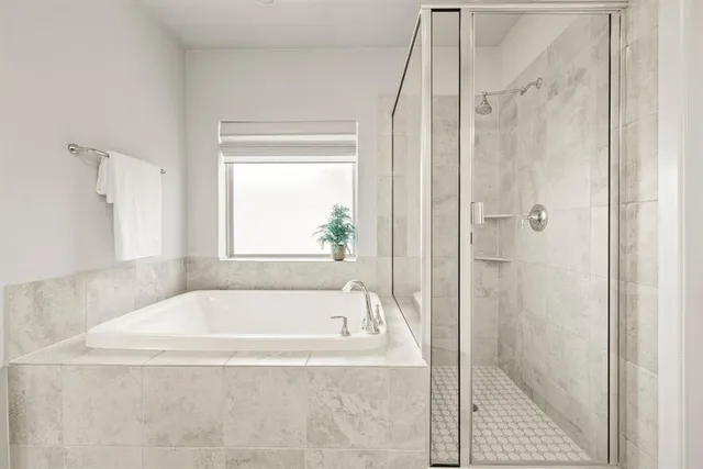 a white bath tub sitting next to a shower