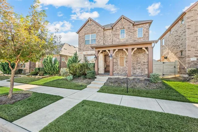 a front view of a house with a garden and plants