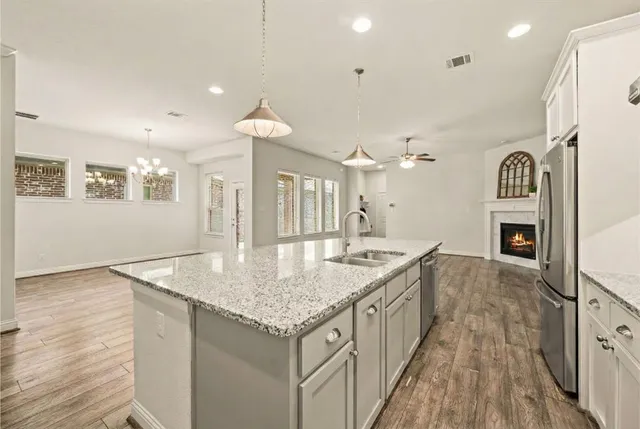 an open kitchen with a sink and breakfast area