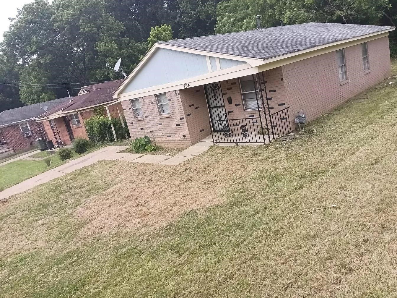 a backyard of a house with table and chairs