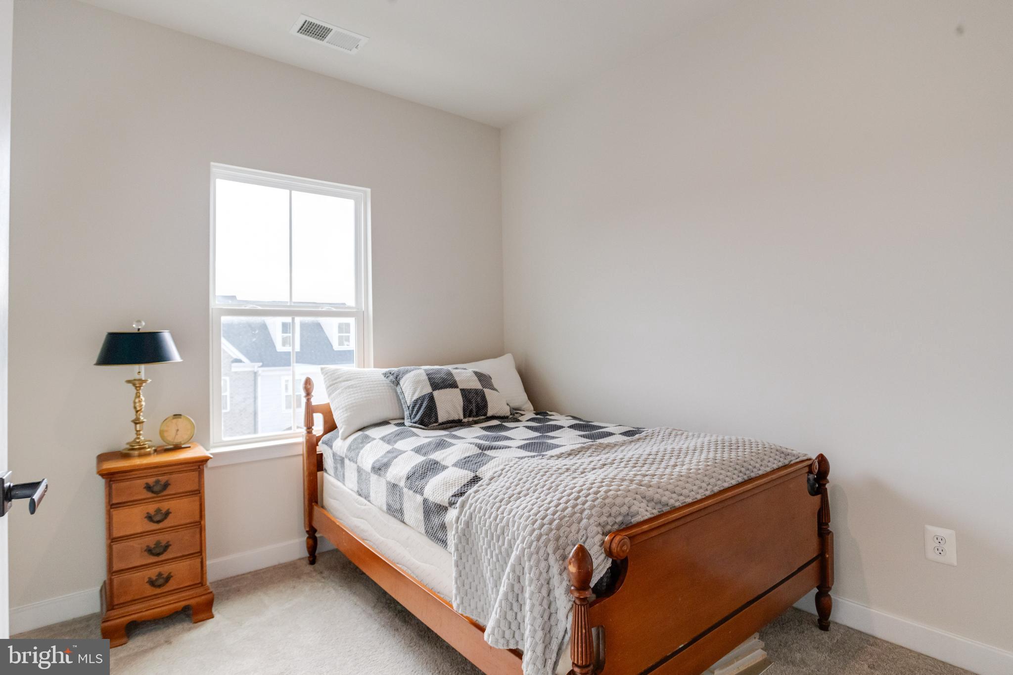 6222 Islington Street Middle River, MD 21220 - Photo 43 of 76 a bed sitting in a bedroom next to a window