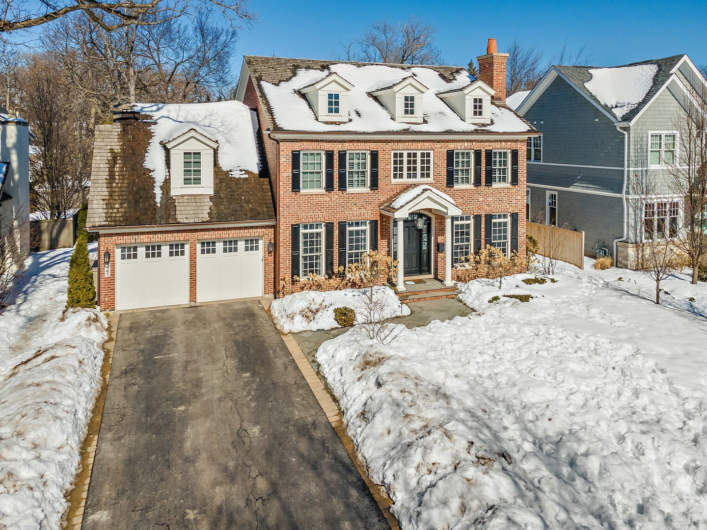 1161 Chatfield Road Winnetka, IL 60093 - Photo 2 of 42 a front view of a house with a yard covered with snow in front of it