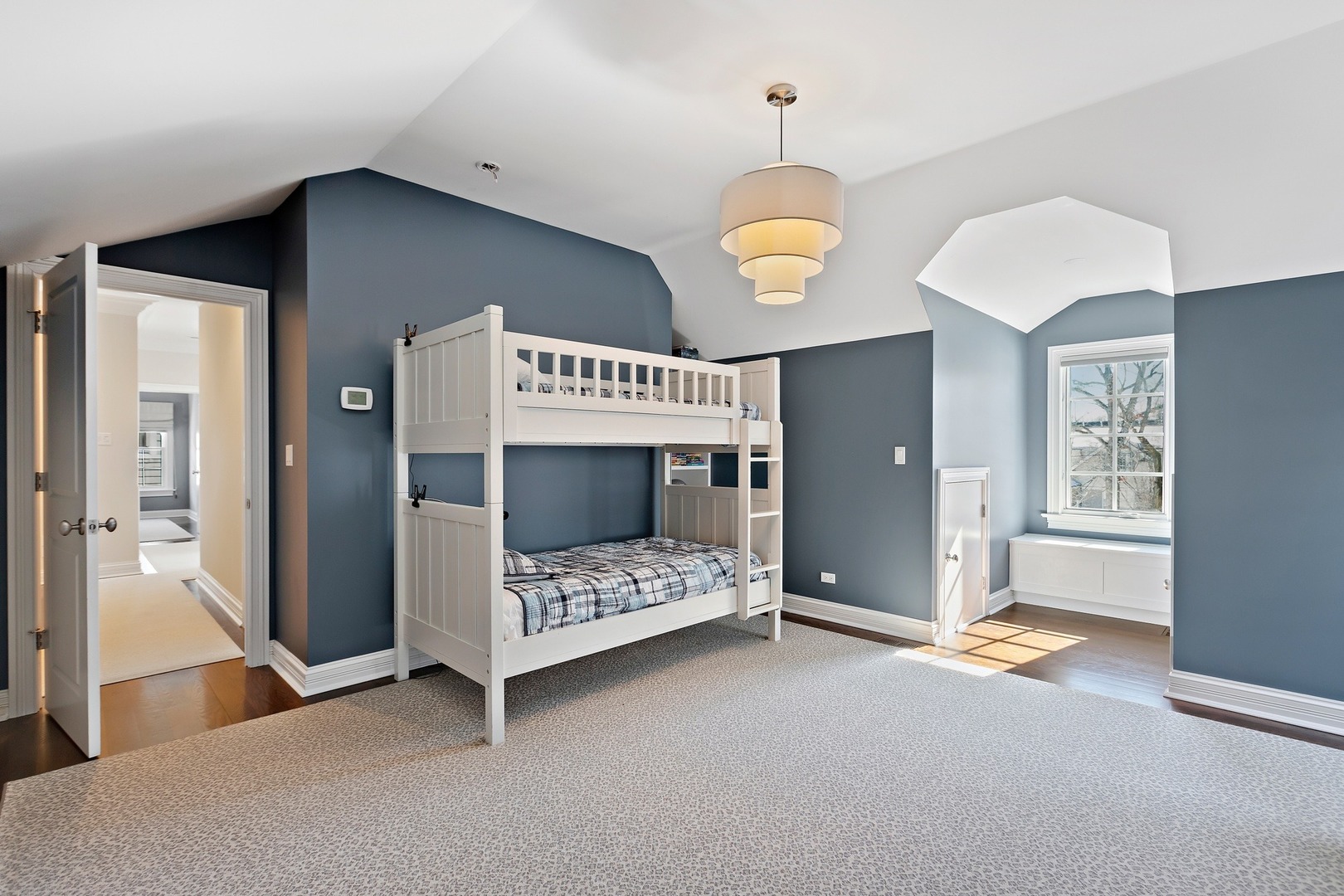 1161 Chatfield Road Winnetka, IL 60093 - Photo 27 of 42 a bedroom with a bed and a chandelier