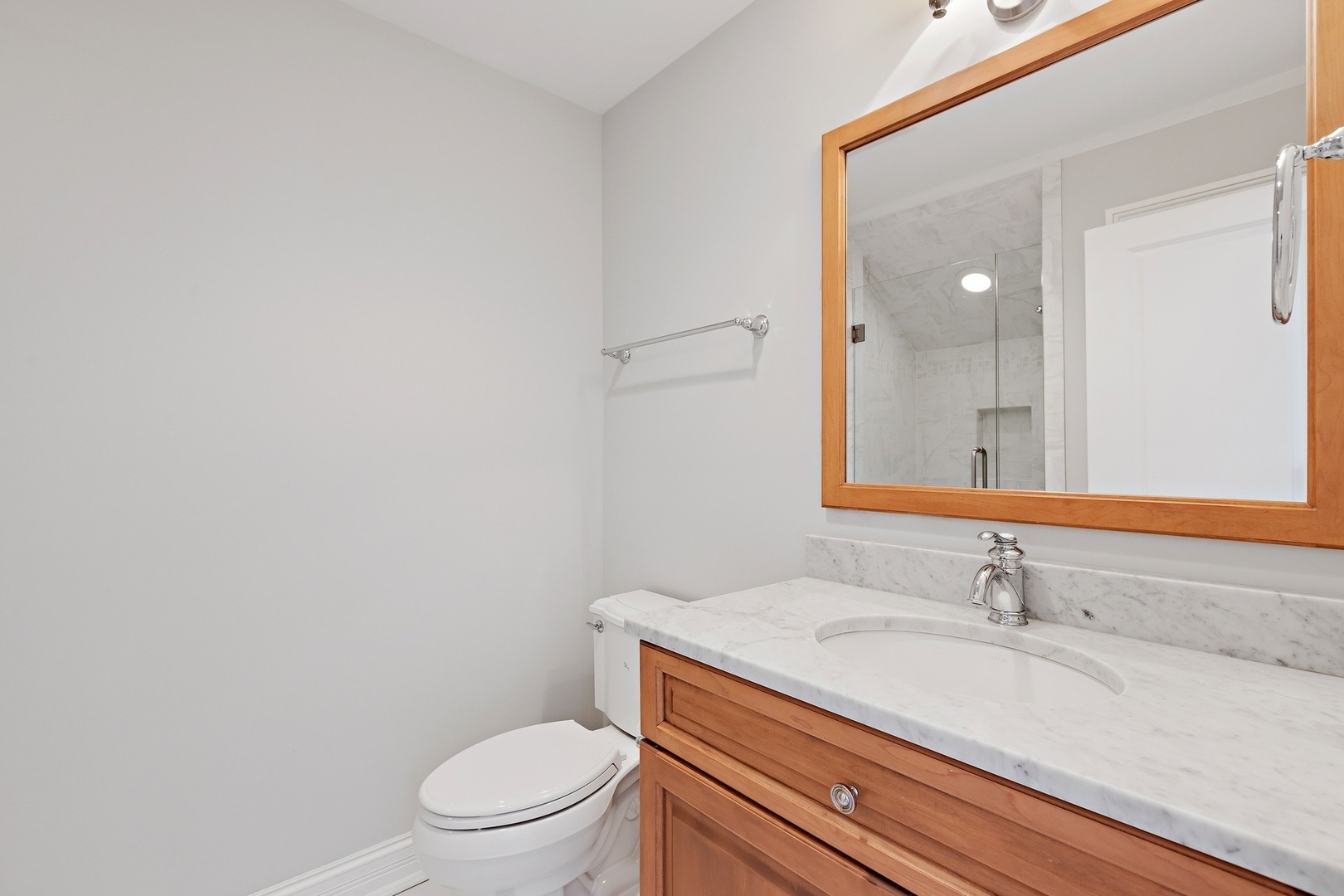 1161 Chatfield Road Winnetka, IL 60093 - Photo 32 of 42 a bathroom with a granite countertop sink a toilet and a mirror