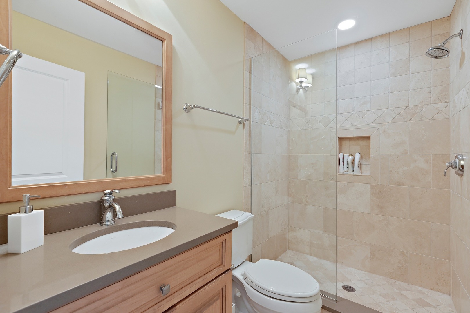 1161 Chatfield Road Winnetka, IL 60093 - Photo 39 of 42 a bathroom with a granite countertop sink toilet a mirror and shower