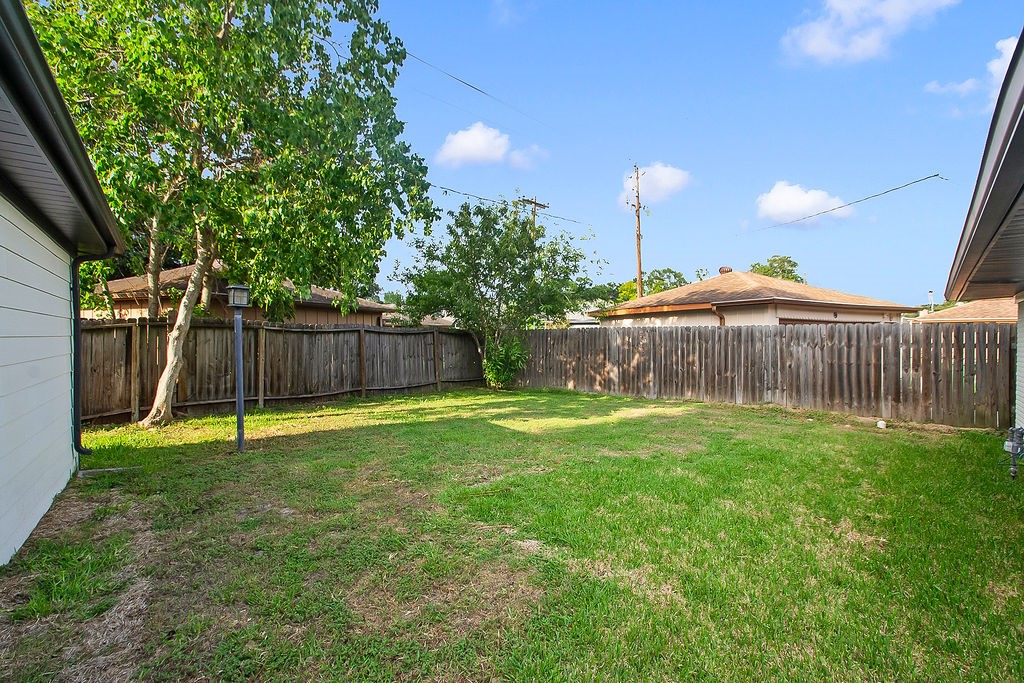 6106 Rutherglenn Drive Houston, TX 77096 - Photo 41 of 41 Additional backyard view showcasing the oversized lot and private outdoor retreat.