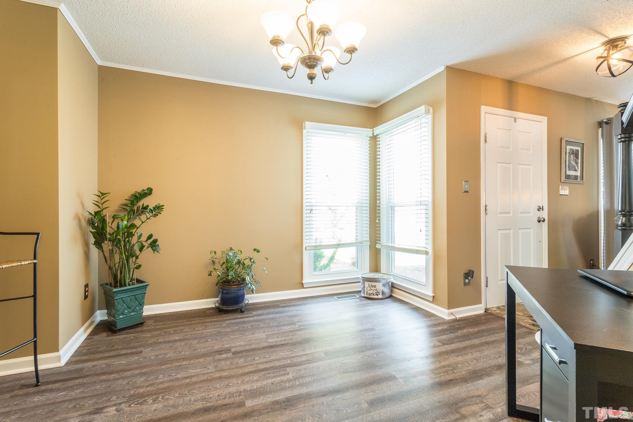 2352 Declaration Drive Raleigh, NC 27615 - Photo 15 of 28 a view of an empty room with a window and wooden floor