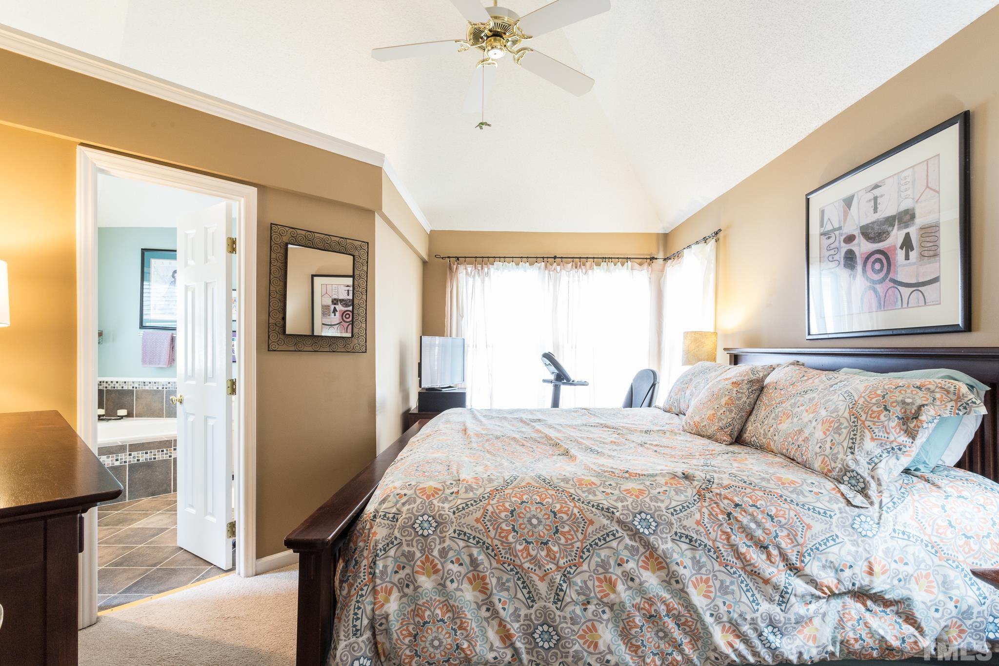 2352 Declaration Drive Raleigh, NC 27615 - Photo 16 of 28 a spacious bedroom with a bed and a chandelier