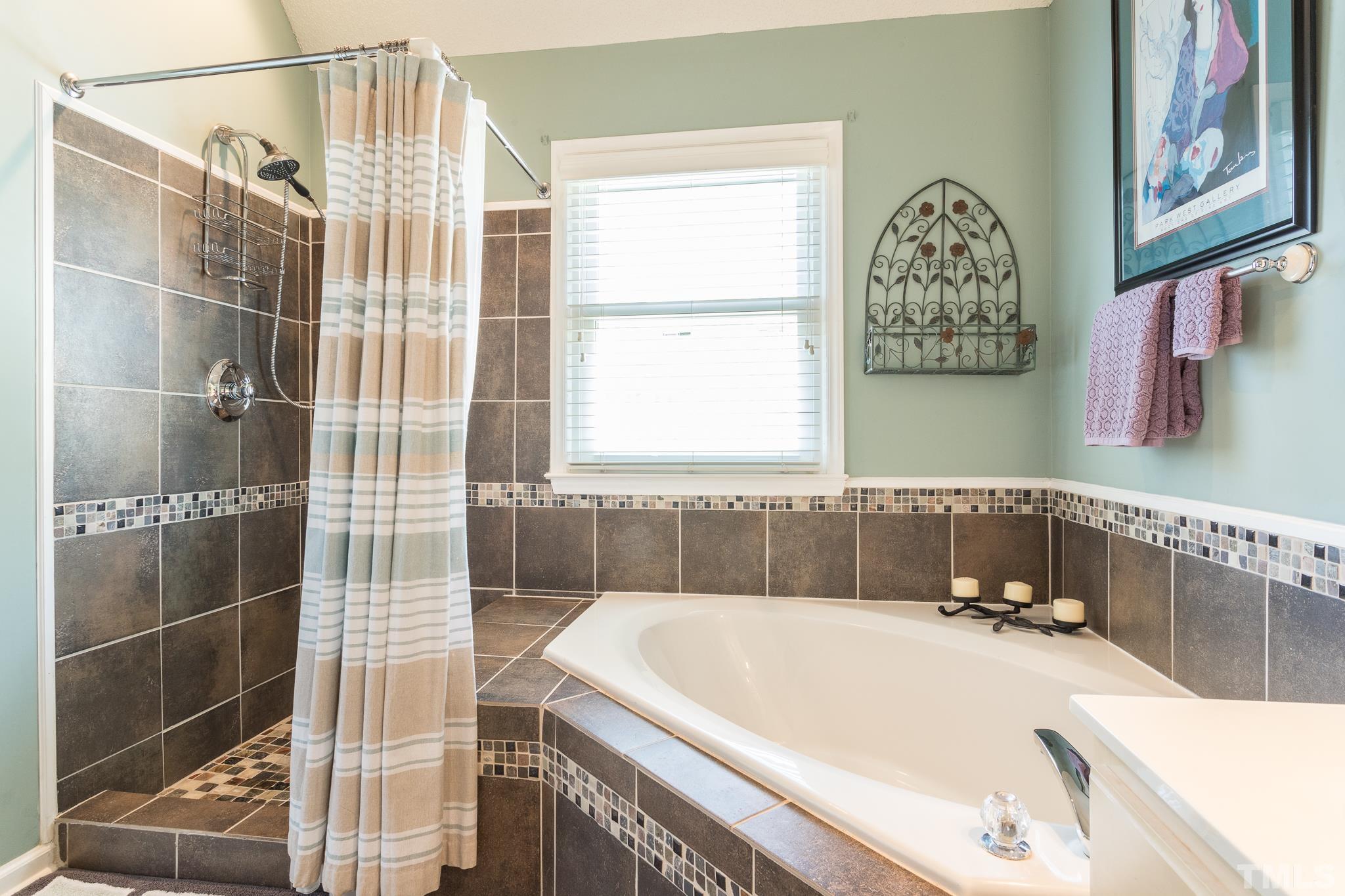 2352 Declaration Drive Raleigh, NC 27615 - Photo 18 of 28 a bathroom with a tub and a window