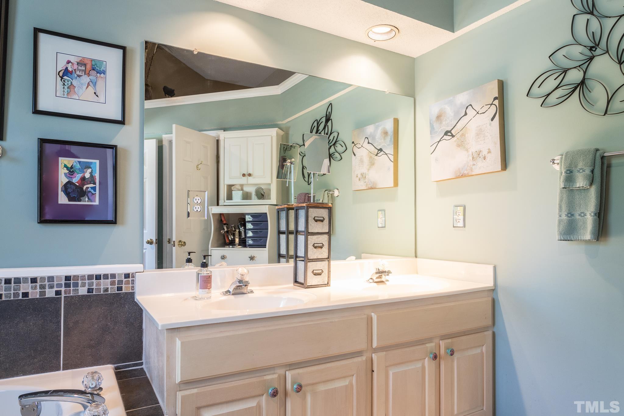 2352 Declaration Drive Raleigh, NC 27615 - Photo 20 of 28 a bathroom with double vanity sink and a mirror