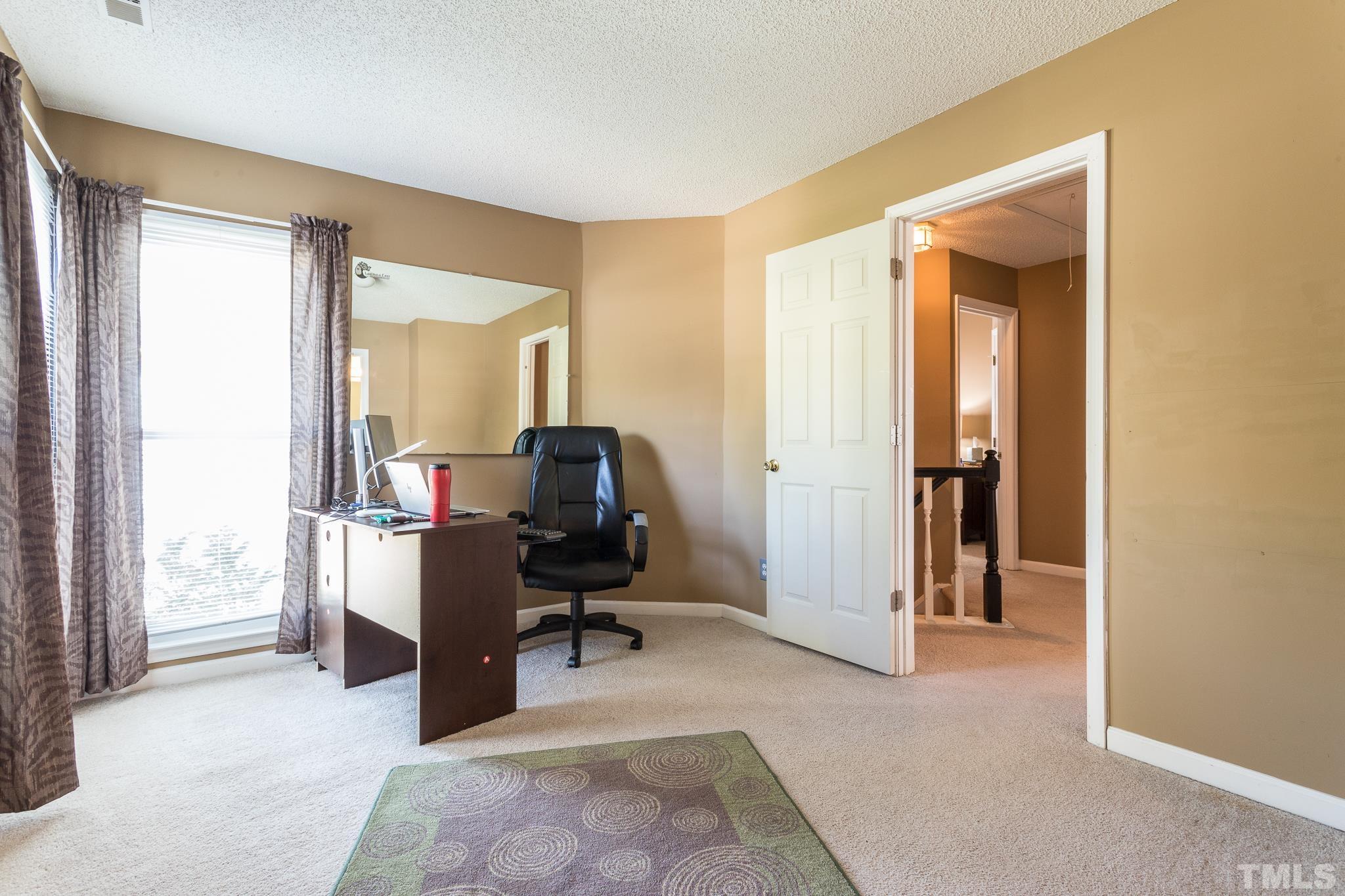 2352 Declaration Drive Raleigh, NC 27615 - Photo 23 of 28 a view of a workspace with furniture and a window