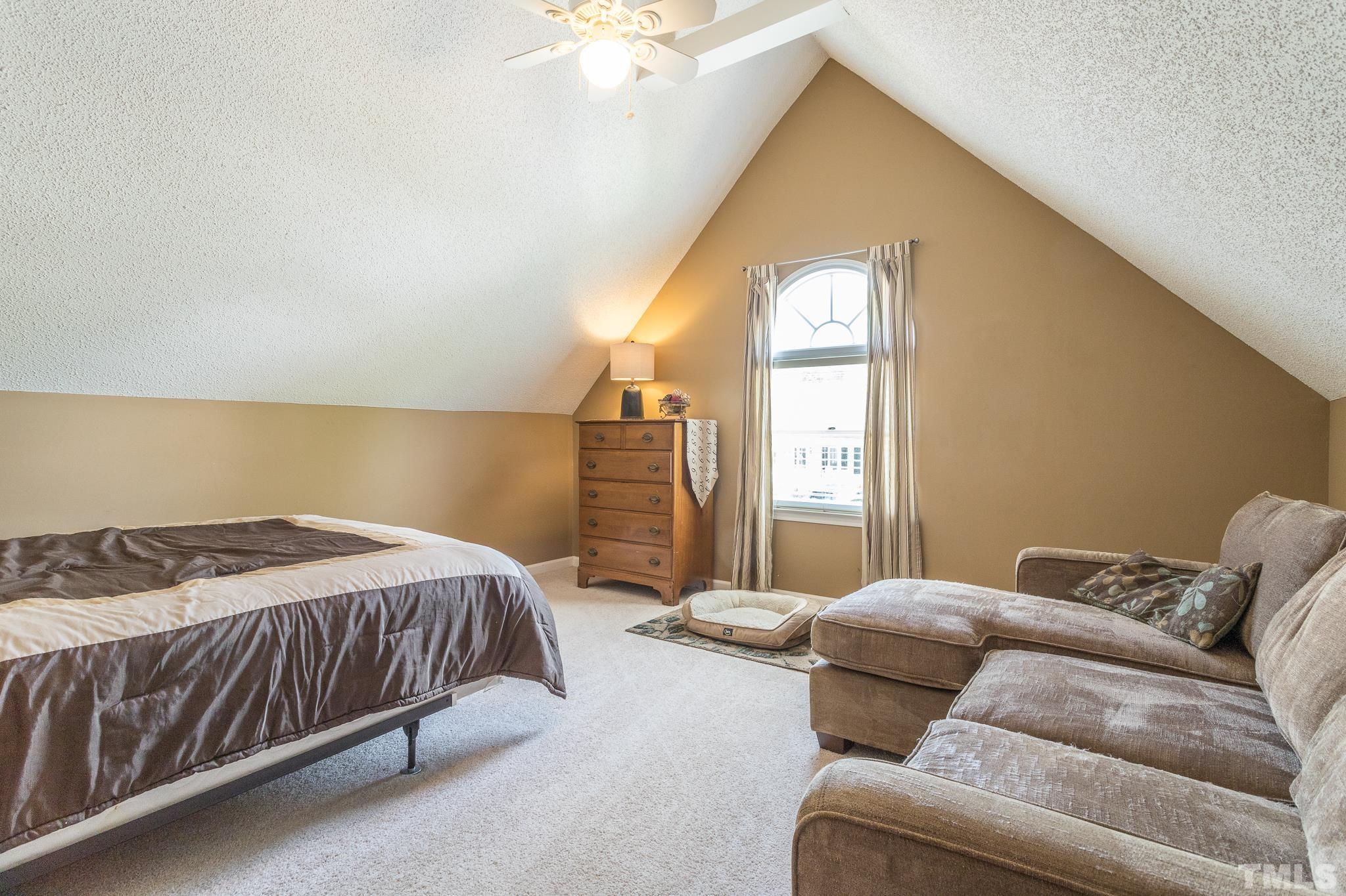 2352 Declaration Drive Raleigh, NC 27615 - Photo 24 of 28 a bedroom with a bed couch and window