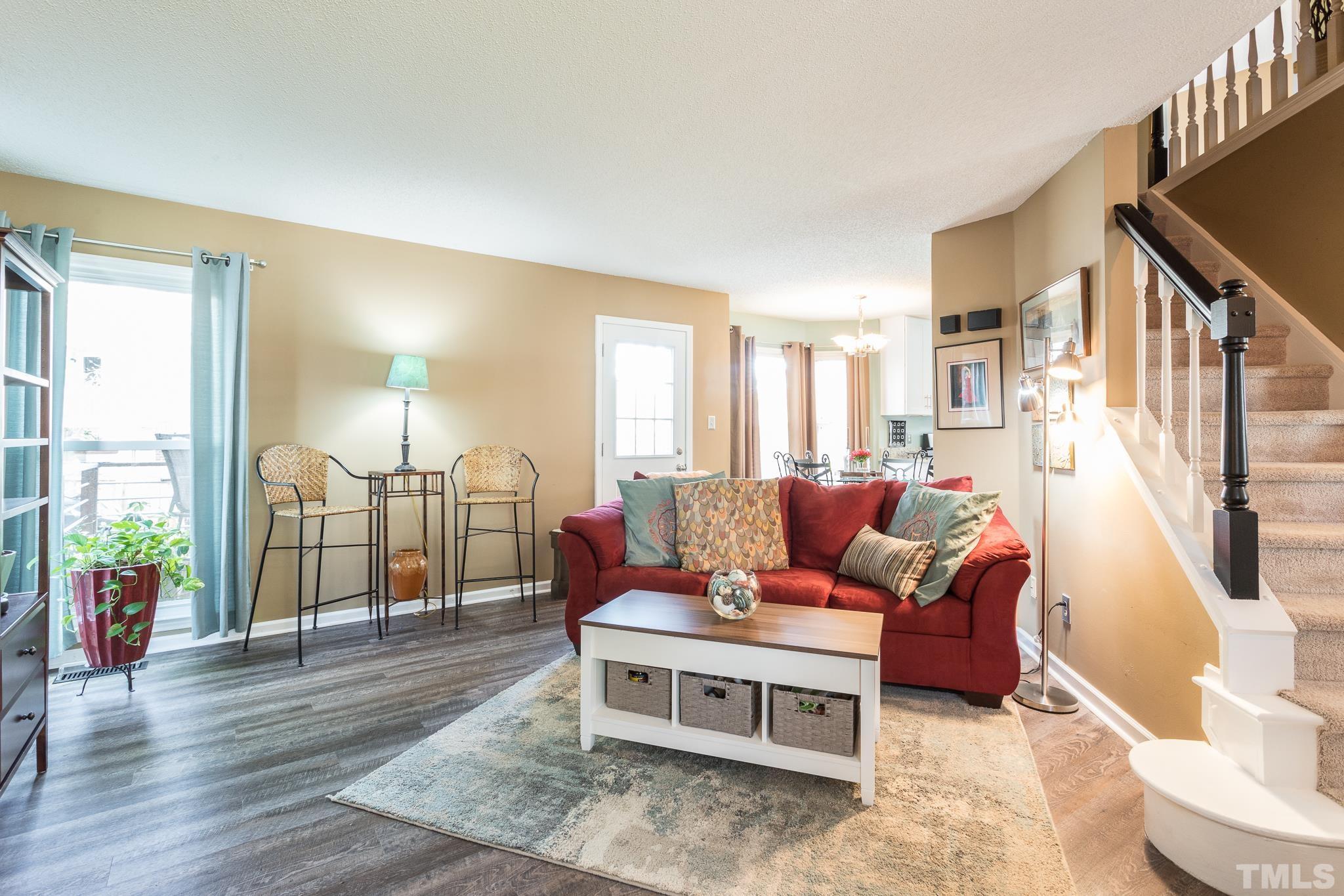 2352 Declaration Drive Raleigh, NC 27615 - Photo 5 of 28 a living room with furniture a wooden floor and a large window