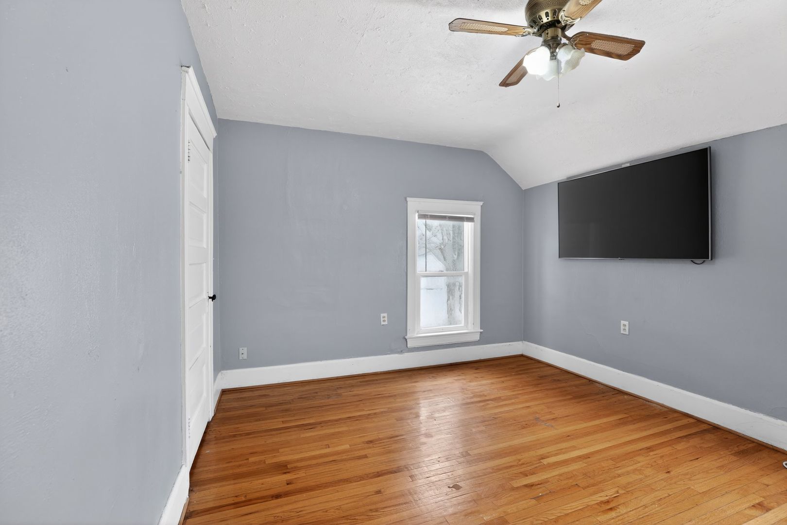1250 West American Street Freeport, IL 61032 - Photo 14 of 23 a view of an empty room with wooden floor and a window